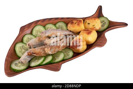 Fried smelt with cucumbers and potatoes in a fish form plate isolated on a white background Stock Photo