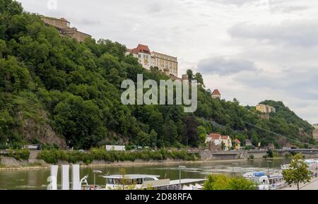 waterside impression of Passau including the Veste Oberhaus and the Veste Niederhaus in Lower Bavaria in Germany at summer time Stock Photo