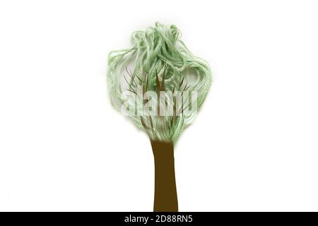 Green tree made of thread on white background. Trunk painted. Copy space. Stock Photo