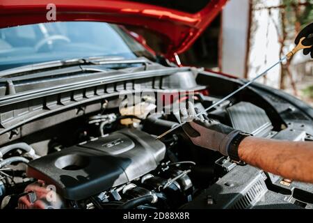 Mechanic examinates the cars technical conditions. Exterior view of a new car Stock Photo
