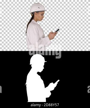 Engineer using mobile phone texting while walking, Alpha Channel Stock Photo