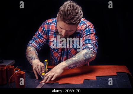 Tanner of leather producing a good product in his workshop Stock Photo