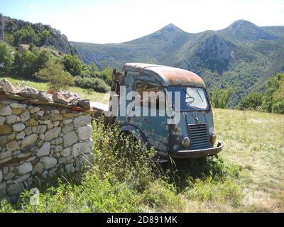 Old abandoned truck in the countryside showing reflection in side window. Stock Photo