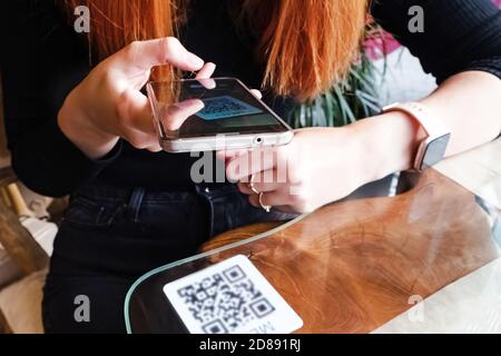 Woman scanning the barcode qr code in restaurant or cafe Stock Photo