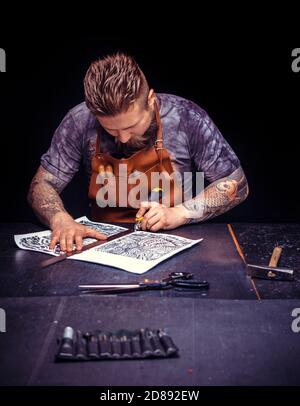 Leather Artisan forms new leather product at the work area Stock Photo