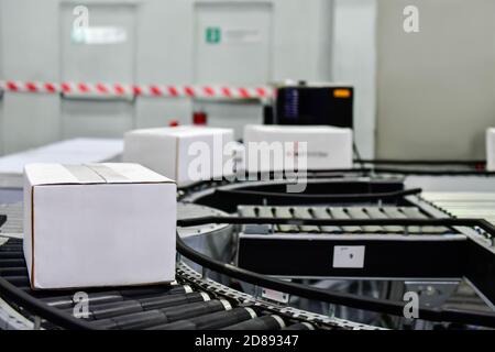 White cardboard boxes on conveyor belt. parcels transportation system concept Stock Photo