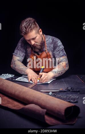 Professional Tanner focusing on his work in workshop Stock Photo