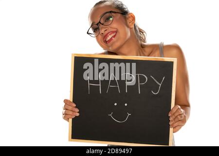 Happy dark skinned woman holding blackboard on white background Stock Photo