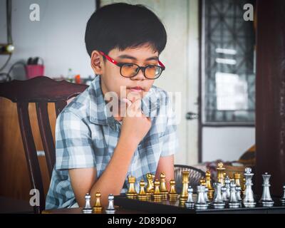 Concentrated serious boy developing chess gambit, strategy ,playing board  game to winner clever concentration and thinking child while playing chess.  Learning, tactics and analysis concept. 7292819 Stock Photo at Vecteezy