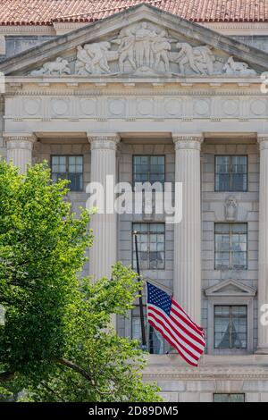 One of the Herbert C Hoover Building's pedimented pavilions on Constitution Avenue NW. Each features sculpture by James Earle Fraser &  Haig Patigian. Stock Photo