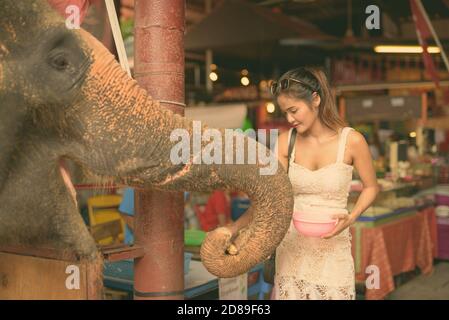 Young beautiful Asian woman having vacation in Ayutthaya, Thailand Stock Photo