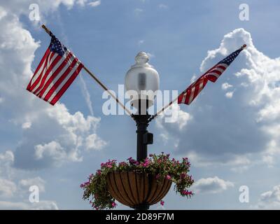 US flags flutter on a lamp standard at Washington Harbour, in Georgetown, Washington DC. Stock Photo