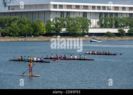 Rowing eights assemble on the Potomac River in front of the John F Kennedy Center for the Performing Arts in Washington DC. Stock Photo