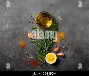 selection of spices, herbs and greens. ingredients for cooking. dark background, top view Stock Photo