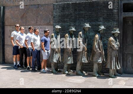 A group of Indian tourists join the Breadline, George Segal's sculpture of the Great Depression at the Franklin Delano Roosevelt Memorial. Stock Photo