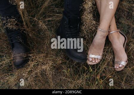 Close-up of a man and woman wearing smart shoes in a field, Russia Stock Photo