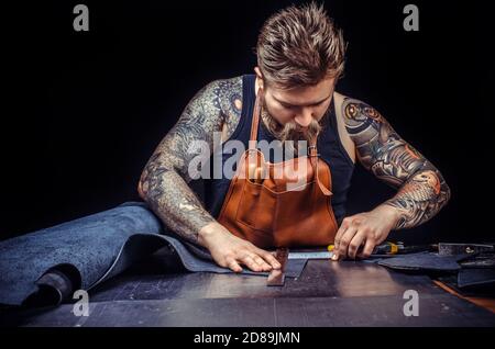 Currier of leather producing a good product in his tanner shop Stock Photo