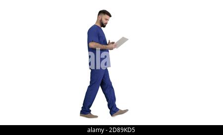 Confident concentrated focused surgeon using digital tablet on w Stock Photo