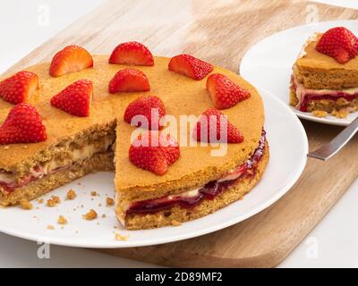 A Vegan Victoria Sandwich cake with strawberries Stock Photo