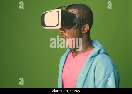 Studio shot of young African man against green background Stock Photo