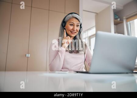 Adult woman teacher working with students on online at the video call Stock Photo