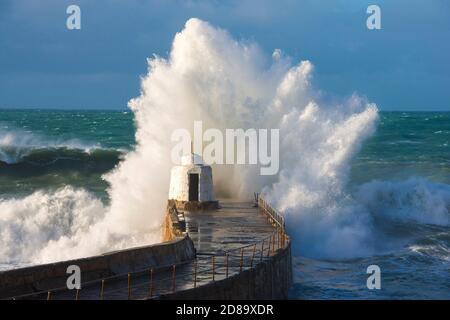 Portreath, Cornwall, UK.  28th October 2020.  UK Weather.   Huge stormy waves whipped up by the remnants of Hurricane Epsilon explode against the harbour wall at Portreath in Cornwall on an afternoon of strong gusty winds and sunny spells during the half term school holidays.  Picture Credit: Graham Hunt/Ģ����ý Live News Stock Photo