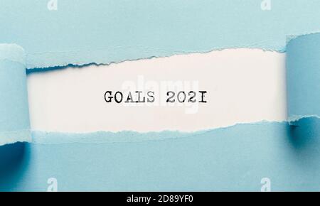 Motivational poster with Goals 2021 text appearing under torn blue paper Stock Photo