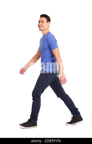 Full length side portrait of happy asian man walking over white background Stock Photo