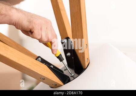 Unrecognizable Man Using Screwdriver Making Table Working Indoor, Closeup, Cropped Stock Photo