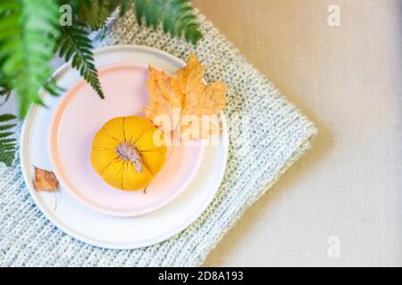 Thanksgiving or Halloween table setting with handmade linen mini pumpkin. The concept of using environmentally friendly natural materials. Stock Photo