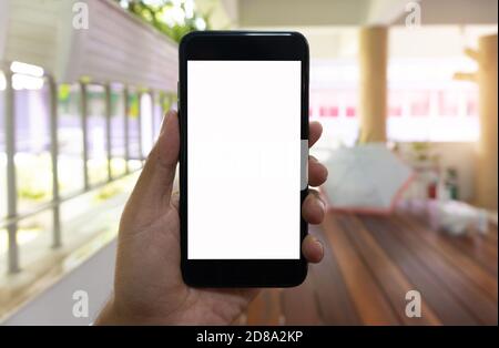 Asian man using hand hold black smartphone, Smartphone mockup background. Stock Photo