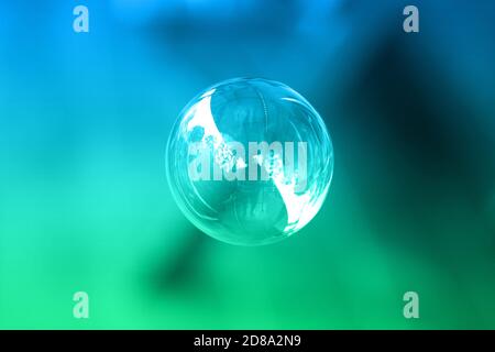1 soap bubble on a green and blue background. Stock Photo