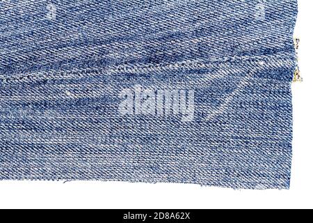 Piece of light blue jeans fabric isolated on white background. Rough uneven edges.