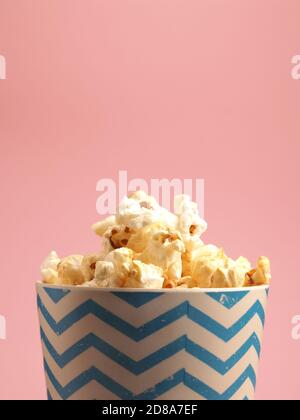 Fresh popcorn on a pink background with space for your text Stock Photo