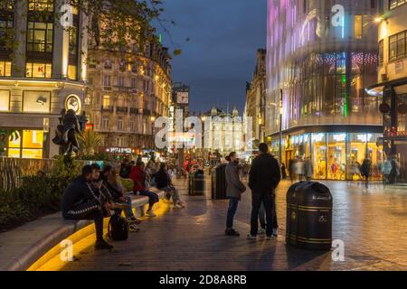 Leicester Square at night with neon lights and people walking around. Long exposure photo. London Stock Photo