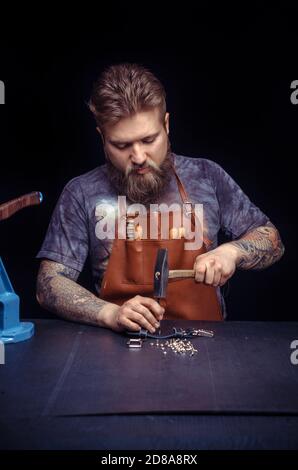 Professional Leather Worker producing leather workpiece Stock Photo