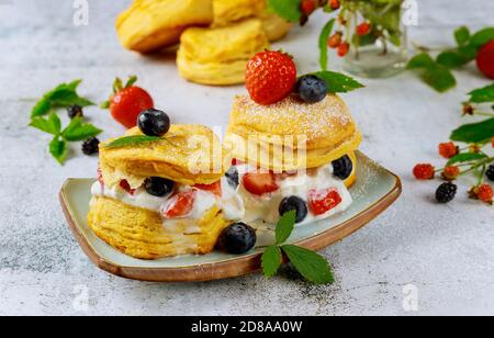 Buttermilk biscuit in plate with berries on white background. Stock Photo