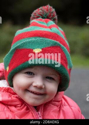 Toddler wearing a bobble hat, UK Stock Photo