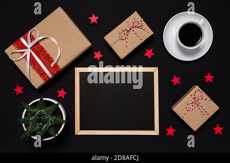 Black Friday sale. Presents, coffee, red stars and blackboard with with copy space for your message on dark background. Shopping and wrapping presents Stock Photo