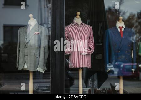 Elegant tailor made suits in a shop window Stock Photo