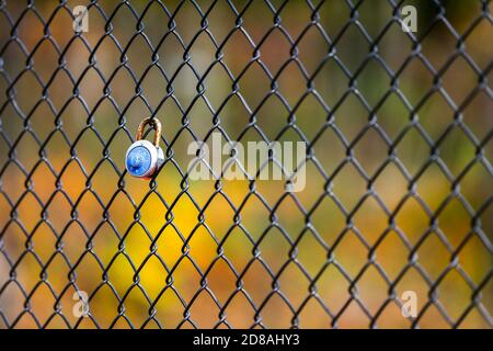A combination lock on a fence Stock Photo