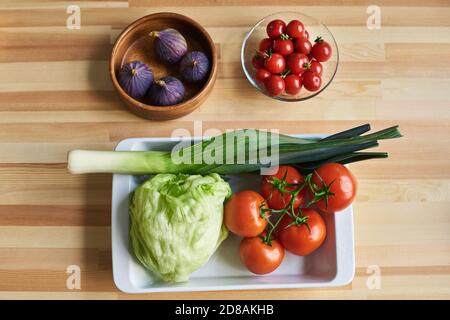 High angle view of fresh vegetables prepared for salad on the wooden table Stock Photo