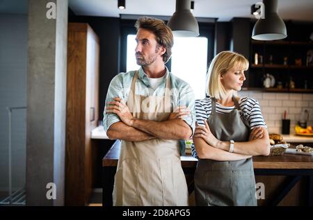 Unhappy couple having argument and fight in kitchen that leads to divorce Stock Photo