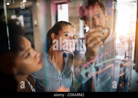 Programmers cooperating at IT company developing apps Stock Photo