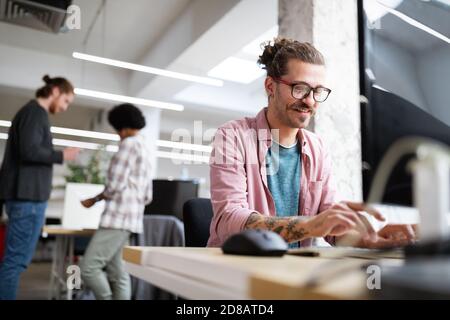 Programmer working and developing software in office Stock Photo