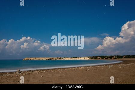 Sandy and pebble beach of the Mediterranean Sea, shot in calm weather at night with a long exposure. Stock Photo