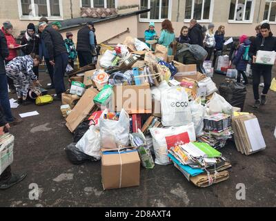 ST. PETERSBURG, RUSSIA-CIRCA MAY, 2019: Teenage school children and parents bring wastepaper on school yard. Scrap paper collecting is in primary Russ Stock Photo