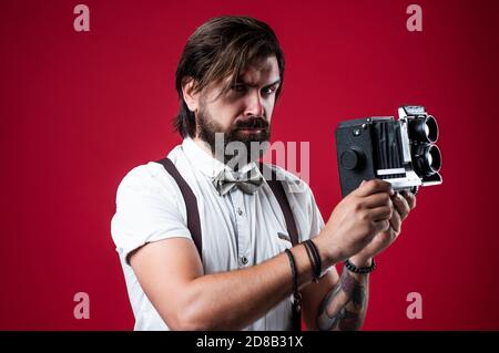 Will you pose for me. photographer hold retro camera. journalist is my  career. reporter make photo. vintage camera. capture these memories. SLR  camera. hipster man with beard use professional camera Stock Photo