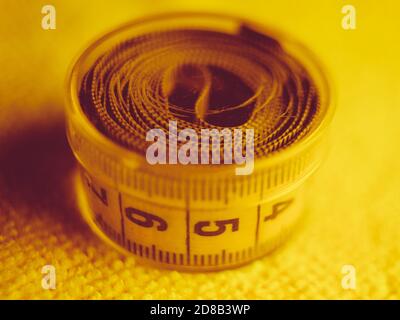 Yellow measuring tape in round box on the towel Stock Photo