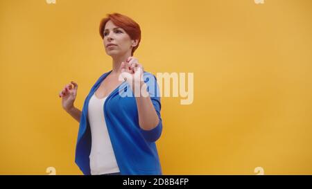 Beautiful redhead short haired woman dancing. . High quality photo Stock Photo